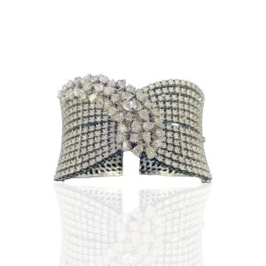 Wide diamond cuff bracelet with multiple rows of pavé diamonds and central floral cluster motif in white gold
