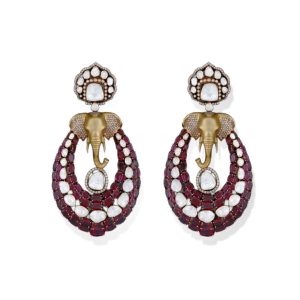 Statement chandelier earrings by Frontier Jewellers featuring gold elephant motifs with polki diamonds and ruby stones.