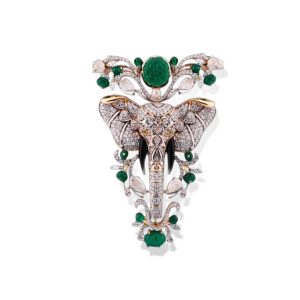 Diamond and emerald elephant brooch by C. Krishniah Chetty and Sons crafted in white and yellow gold with intricate gemstone detailing.