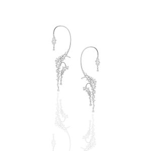 Asymmetrical diamond ear cuff earrings with cascading diamond drops worn along the ear.