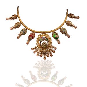 Heritage gold necklace with colourful pendants styled on silk textile backdrop