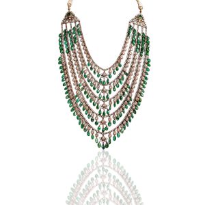 Multi layer polki necklace with emerald bead drops displayed on a deep red mannequin by Krishna Jewellers.