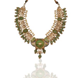 Traditional polki necklace with green stones and enamel details by Symetree Fine Jewels against carved wooden backdrop.
