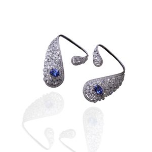 White diamond earrings with blue sapphire centre stones in a curved teardrop design