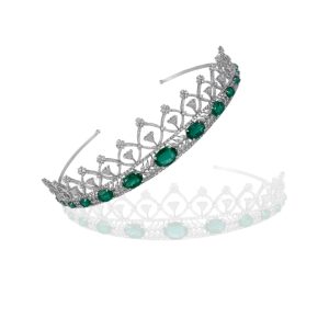 Close up of emerald and diamond tiara by Khurana Jewellery House featuring aligned oval emeralds and intricate diamond lattice framework.