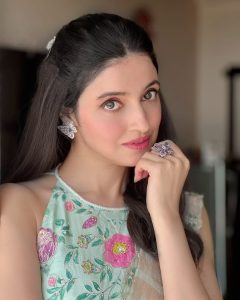 Divya Khosla wearing butterfly diamond earrings and a statement ring by Mohan Shyam Kalyandas Jewellers with a pastel embroidered outfit.