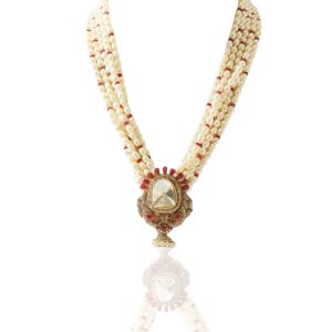Multi strand natural pearl necklace with polki and ruby pendant by SS Jewellers displayed on a beige bust.