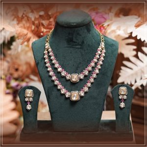Double layered polki necklace with matching earrings by SRD Jewels Couture displayed on a dark green mannequin with soft floral background.