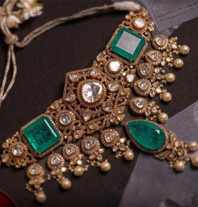 Heavy polki choker with large emerald stones and pearl drops by The House of MBJ from the Mughal Garden collection.