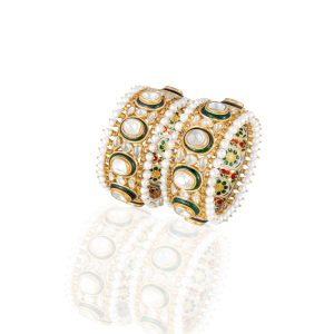 Pair of polki and pearl gold bangles with enamel detailing by VCJ Bespoke Jewellery on a white display surface.