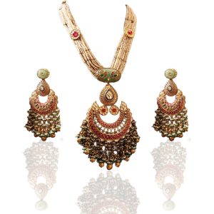 Long raani haar pearl necklace with ornate gold and gemstone pendant by Verma Jewellers with matching earrings.