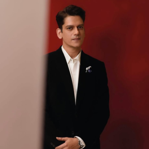 Vijay Varma wearing a sculptural brooch on a textured suit showcasing jewellery by Mahesh Notandass.
