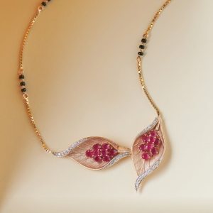 Leaf motif mangalsutra with ruby stones by Manubhai Jewellers