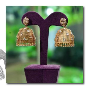 Textured gold jhumka earrings with diamond accents by Mahesh Notandass
