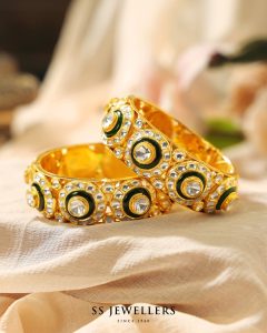 Polki bangles with green beads in antique gold finish by SS Jewellers