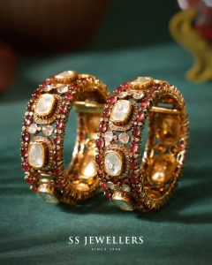 Ruby and polki studded bangles in oval setting by SS Jewellers