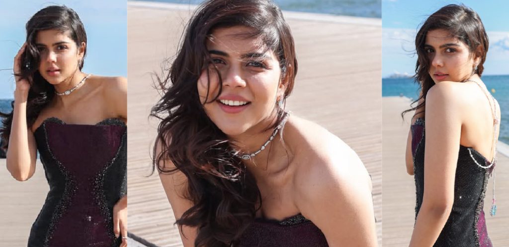 Kalyani Priyadarshan in a shimmering black gown styled with delicate diamond back-chain jewellery featuring pastel gemstone accents by Kalyan Jewellers at Cannes 2026.