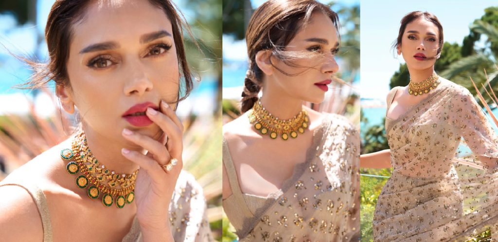 Aditi Rao Hydari in a shimmering beige saree styled with a traditional green and gold heritage choker by Indriya at Cannes 2026.