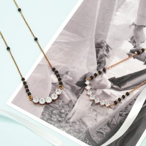 Diamond curved mangalsutra with black beads by Dhirsons Jewellers