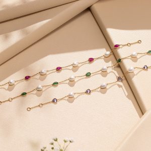 Gold bracelet with pearls and coloured gemstones by Akshaya Gold & Diamonds