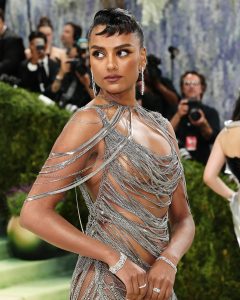 Simone Ashley wearing De Beers diamond earrings and bracelets with metallic dress at Met Gala 2026