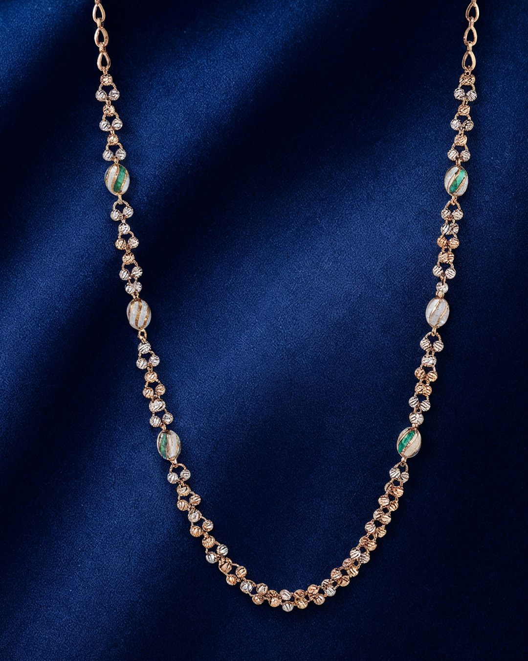 18KT rose gold necklace featuring textured beads and soft green accent elements by Manubhai Jewels