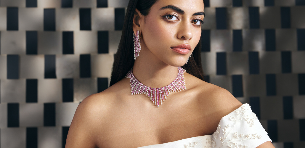 Model wearing a pink sapphire and diamond choker necklace with matching earrings from Hazoorilal Legacy Facets collection.