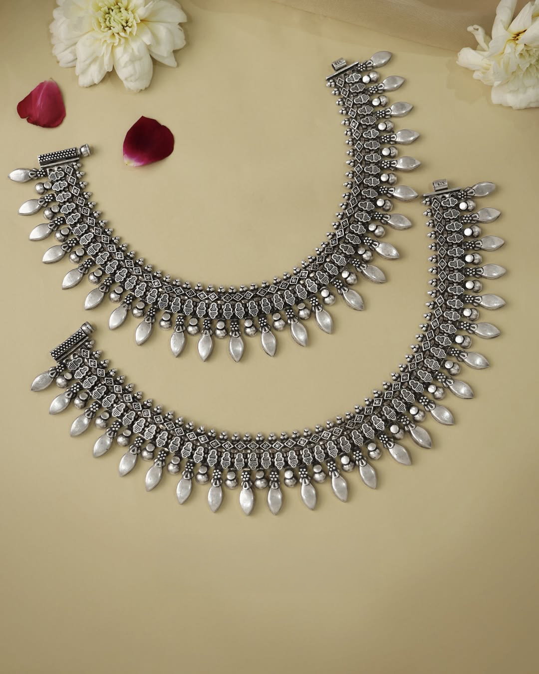 Geometric-pattern silver payal with oxidised finish, intricate craftsmanship, and bold silver drop accents by Navrattan Jewellers.