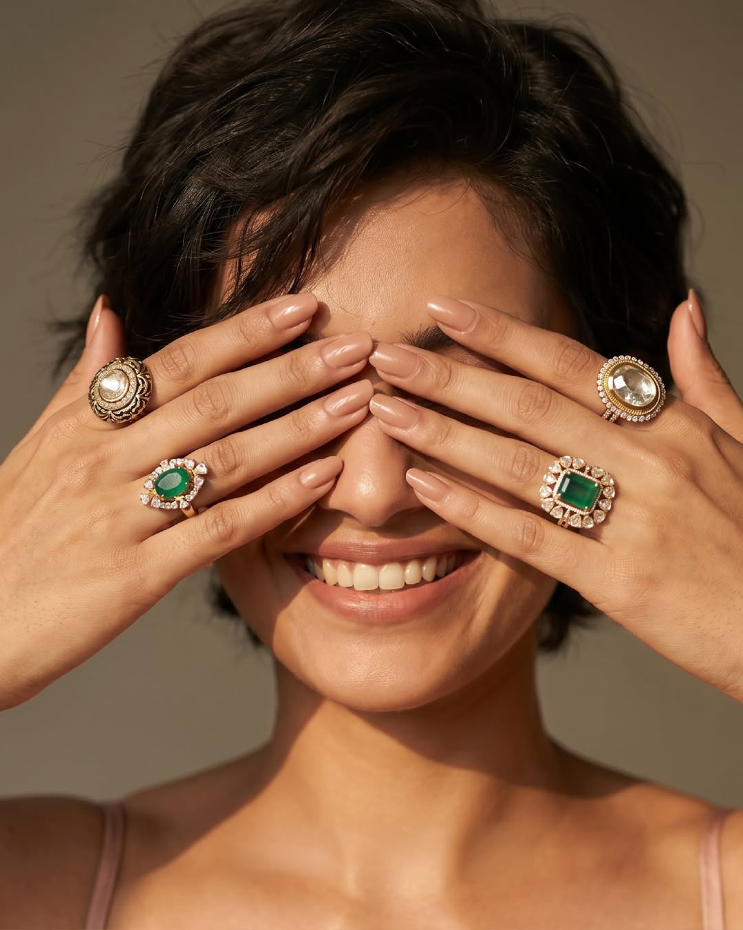 Woman wearing designer Polki and emerald rings by Verma Jewellers featuring uncut diamonds, gemstone accents, and modern fine jewellery styling