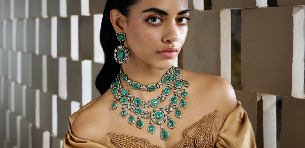 Statement emerald and diamond necklace with matching chandelier earrings from Hazoorilal Legacy Facets collection.