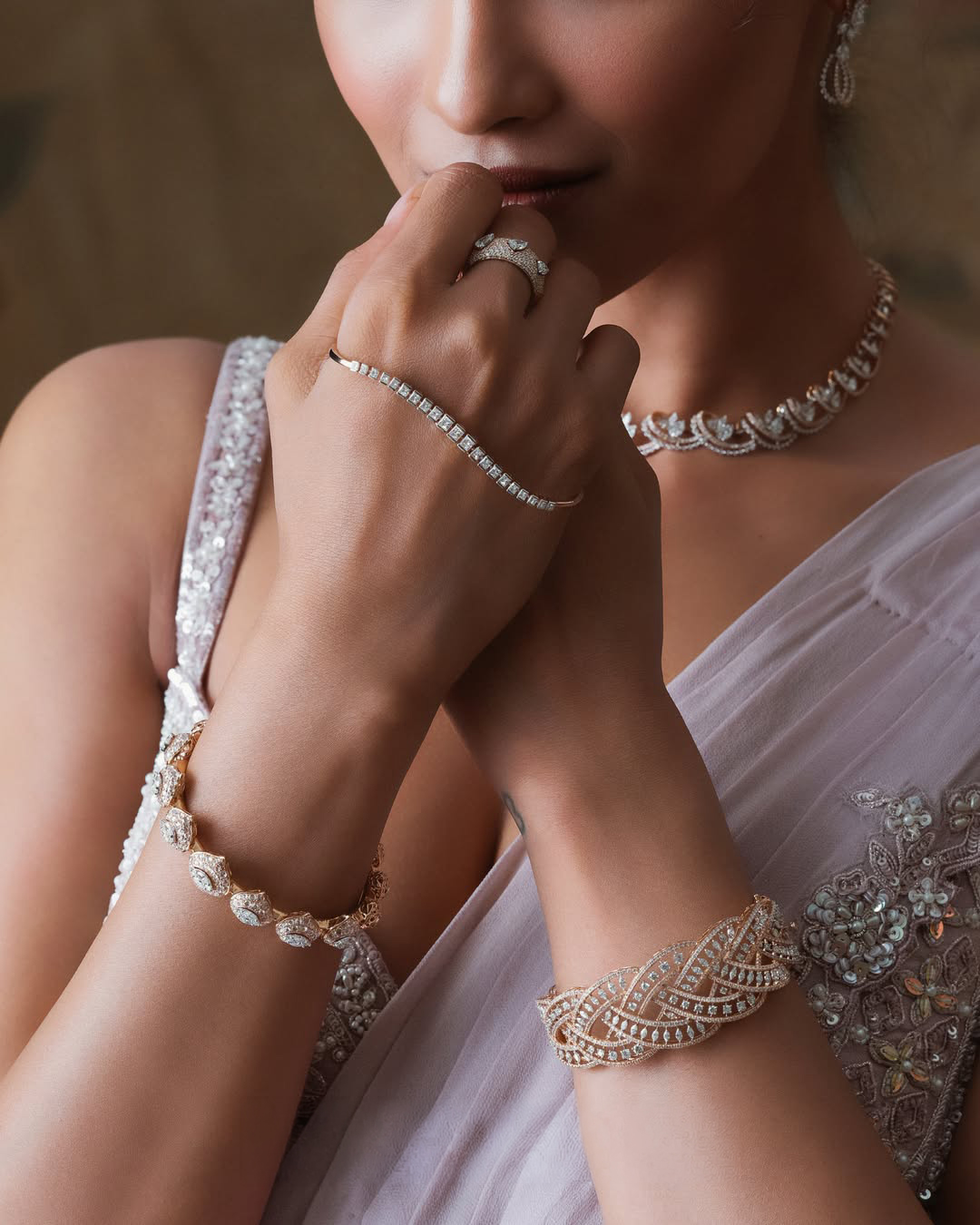 Elegant diamond hand chain by Sumeet Jewellers paired with matching diamond jewellery for a contemporary bridal look