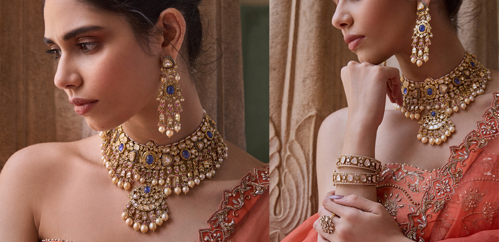 Bride in coral embroidered ensemble wearing blue gemstone and Polki choker necklace with matching chandelier earrings and bangles by Kalavarni Jewels