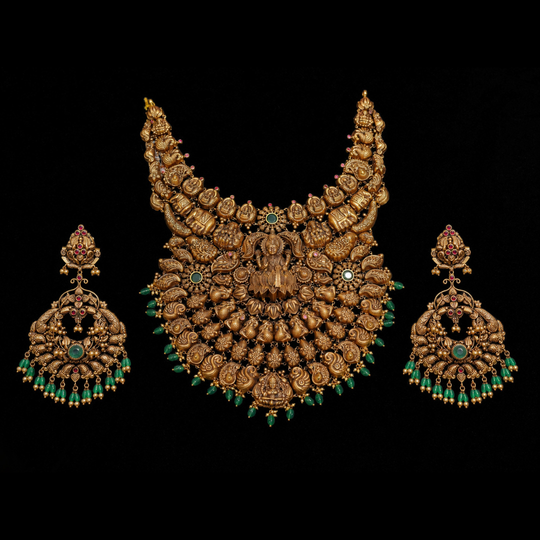 AJB Fine Jewels Grihalakshmi gold bridal necklace and earrings featuring Goddess Lakshmi, elephants and paisley motifs