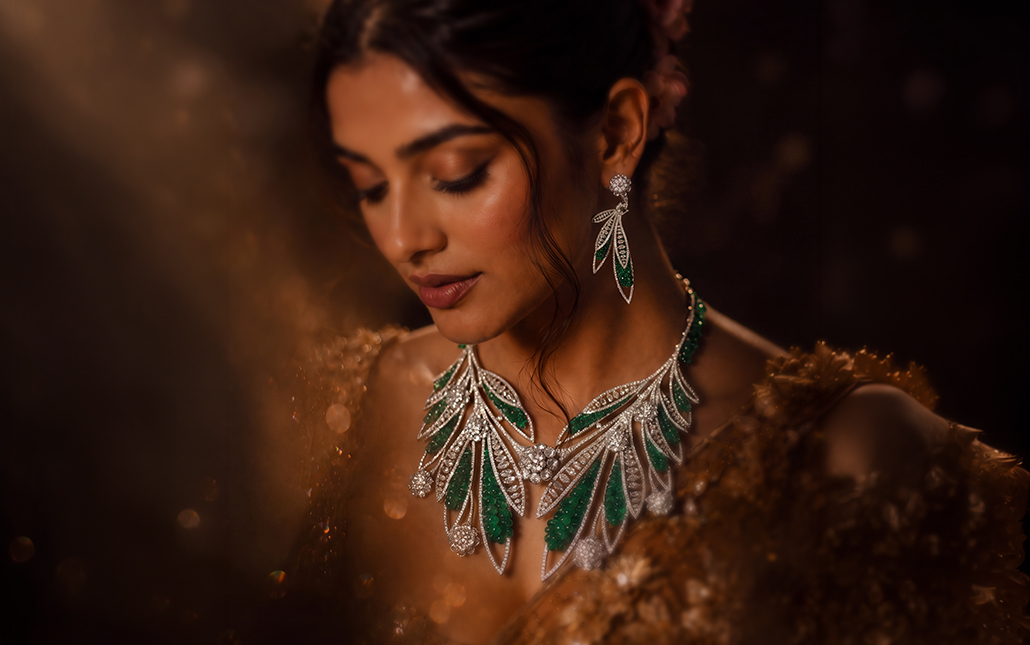 Model wearing D.P. Jewellers’ Whispers of the Eternal Grove bridal necklace and earrings featuring green gemstones and diamond-set leaf motifs.