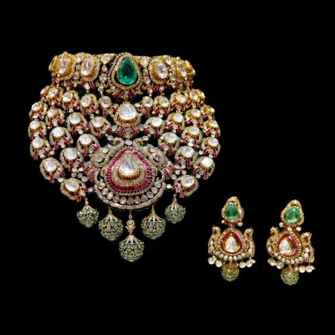 SS Jewellers The Guarded Wing bridal Polki necklace and earrings with layered peacock-inspired detailing and green gemstone accents. 