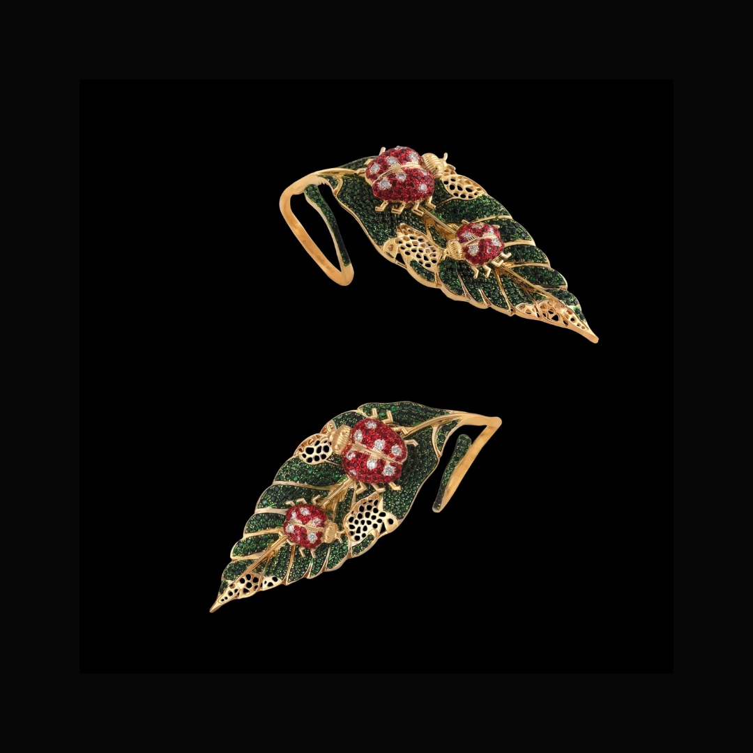 The Star Bugs rings by Sawansukha Jewellers featuring red ladybirds on sculptural green leaves with intricate gold detailing.