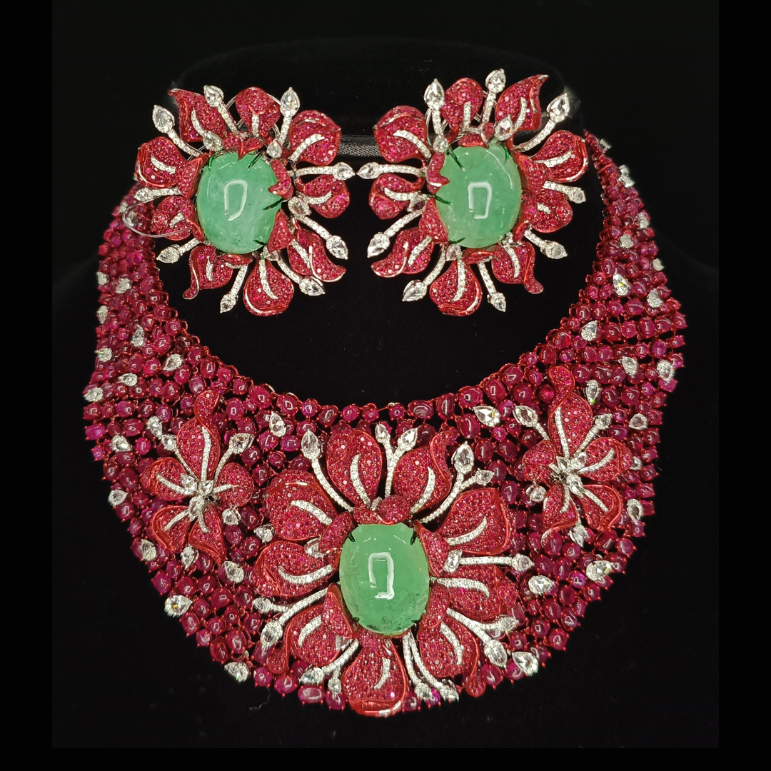 Flora Regalis precious coloured gemstone bridal necklace by Sumeet Jewellers featuring vivid red and green floral motifs.