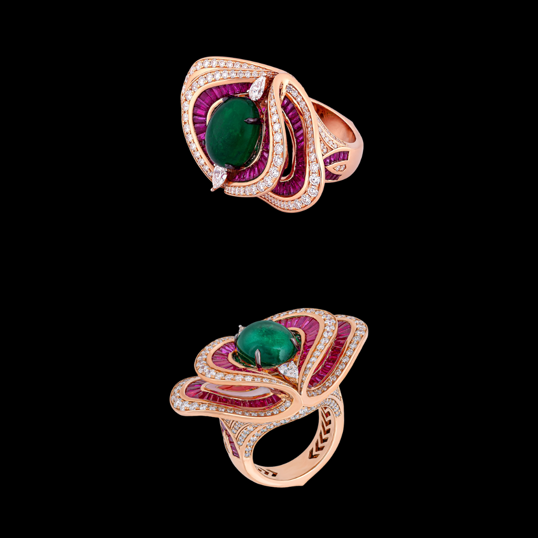 Crimson & Verdure precious coloured gemstone ring by Vummidi Bangaru Jewellers featuring a green centre stone surrounded by layered crimson and diamond-set forms.