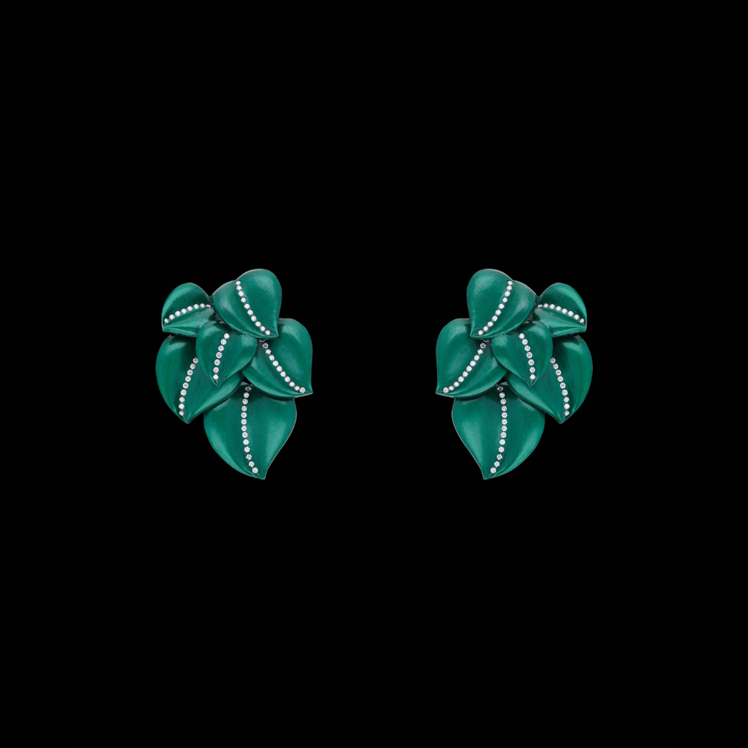 The Verdoyance earrings by C. Krishniah Chetty & Sons featuring sculptural layered green leaves with delicate diamond detailing. 