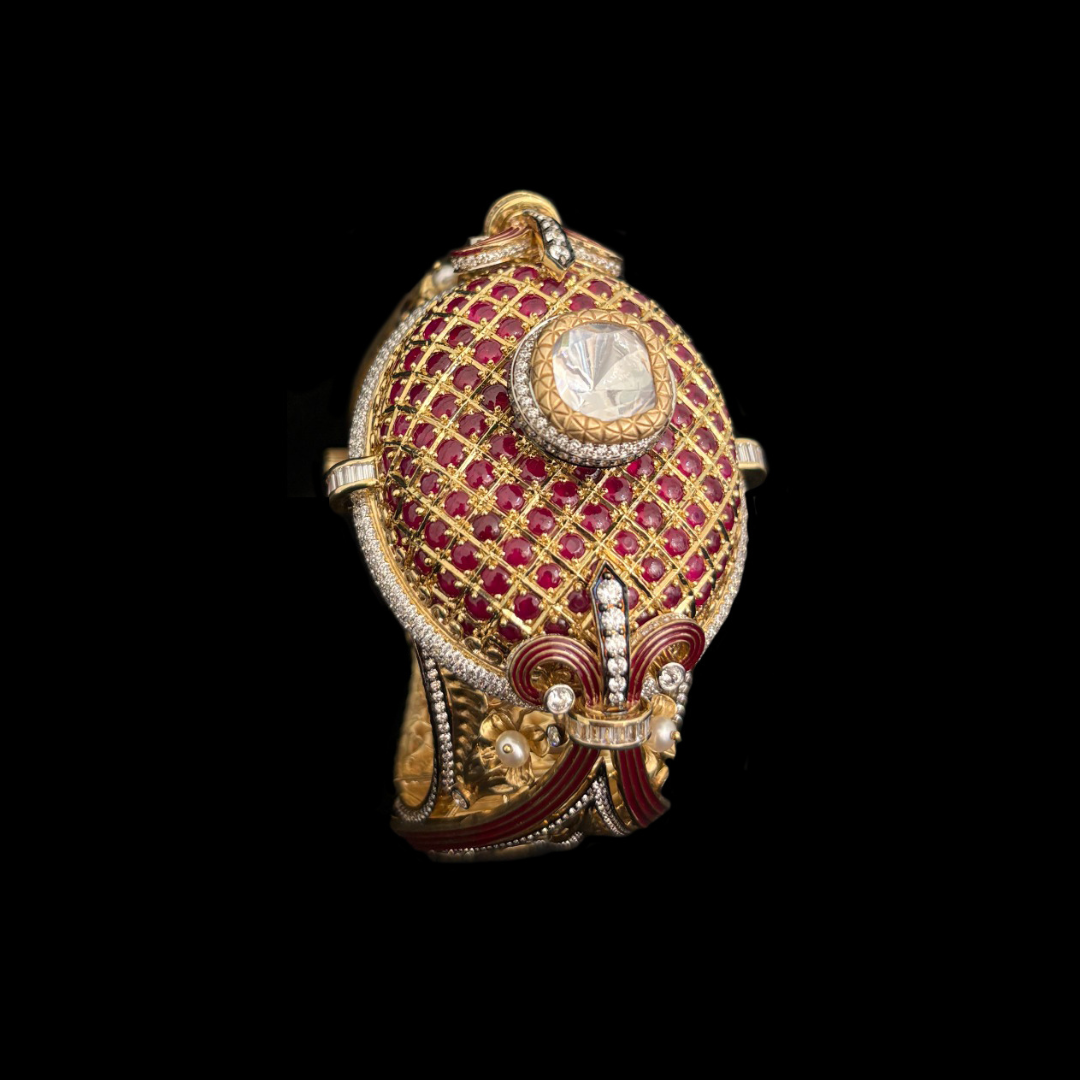 DC Jewellers The Crimson Lattice studded gold bracelet featuring crimson gemstones, lattice-inspired detailing and an ornate central stone. 