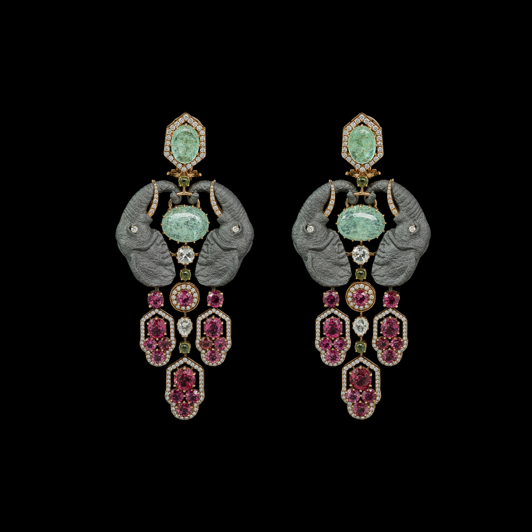 Kalavarni Jewels Gaja Dvandva couture earrings featuring twin elephant motifs, green centre stones and pink gemstone drops.