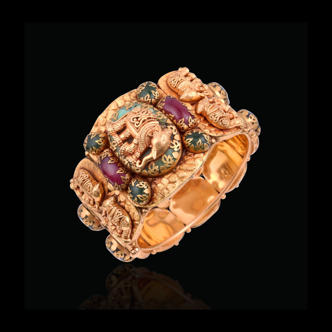 Khurana Jewellery House Aranya studded gold bracelet with sculpted elephants, floral motifs and green and purple gemstone accents.