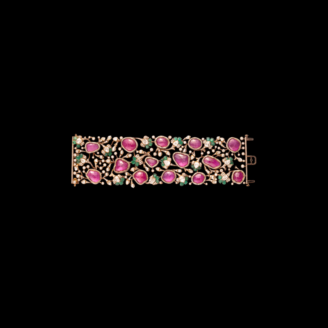 Neelkanth Jewellers The Verdant Lace precious coloured gemstone bracelet featuring pink and green gemstones in a floral vine-inspired design. 
