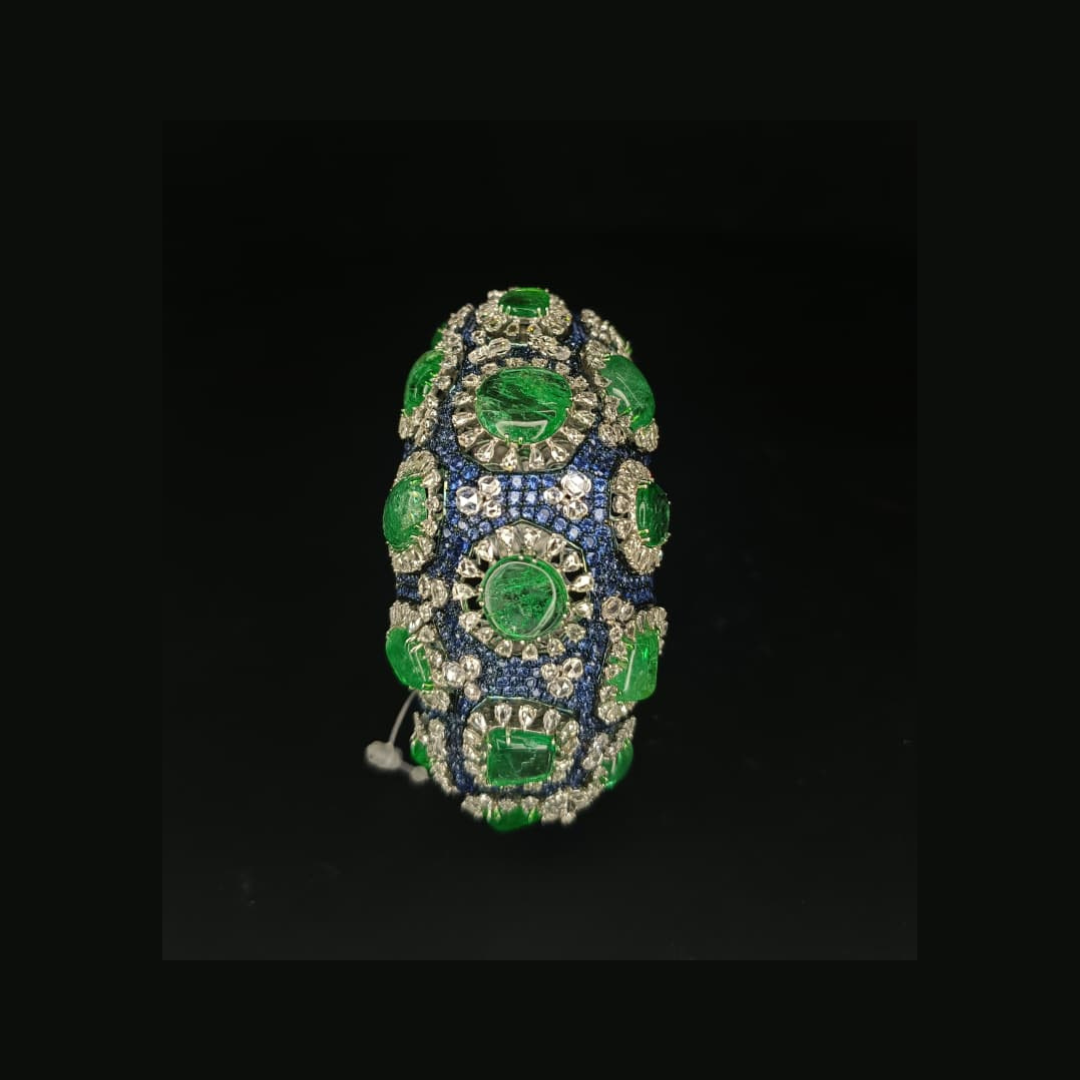 Sumeet Jewellers Stellar Mosaic bangle featuring vivid green and blue precious coloured gemstones with sparkling white stones. 
